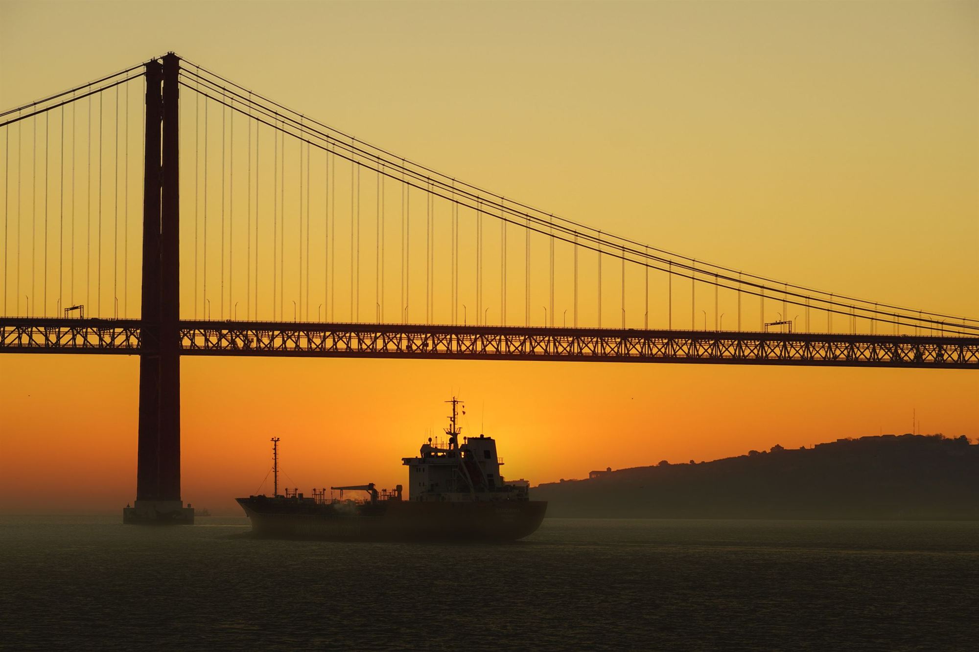 The 25 de Abril bridge in Lisbon at golden sunset