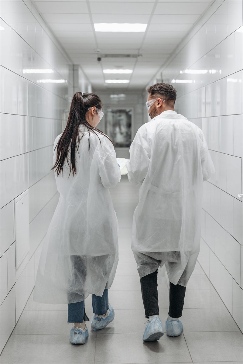 Two doctors walking down a hospital corridor