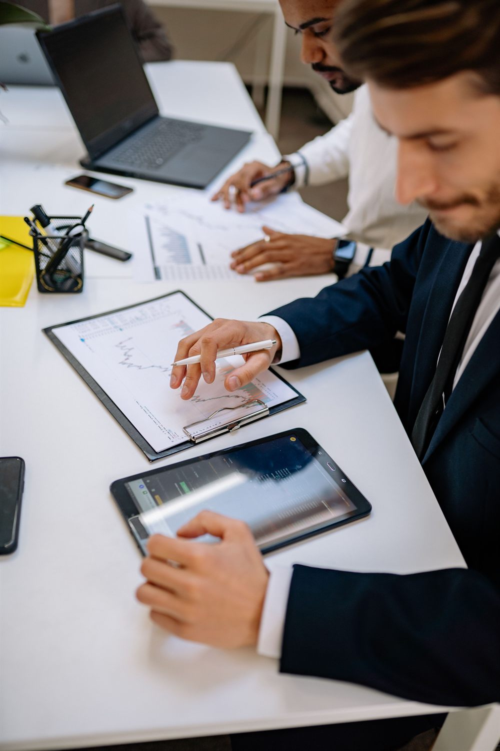 Advisors reviewing market data and financial charts