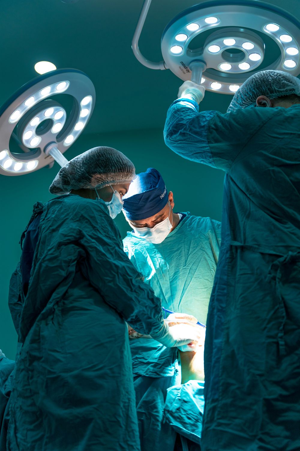 A fully equipped operating theatre with a surgical team at work