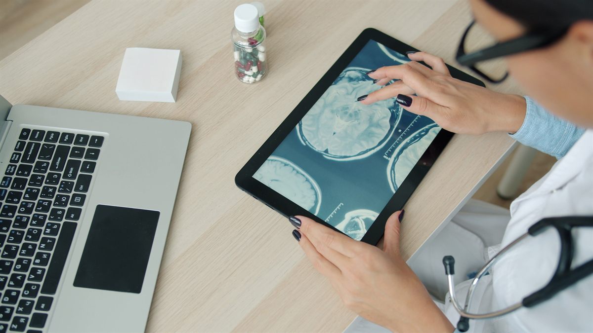 A clinician reviewing diagnostic imaging on a tablet