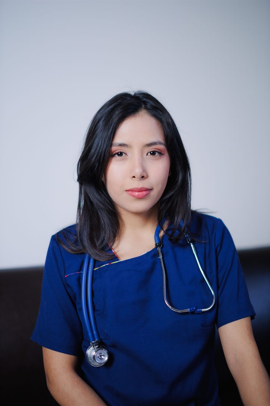 A nurse in blue scrubs
